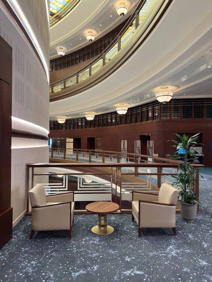 Luxurious modern hotel interior featuring stylish armchairs and mezzanine view.