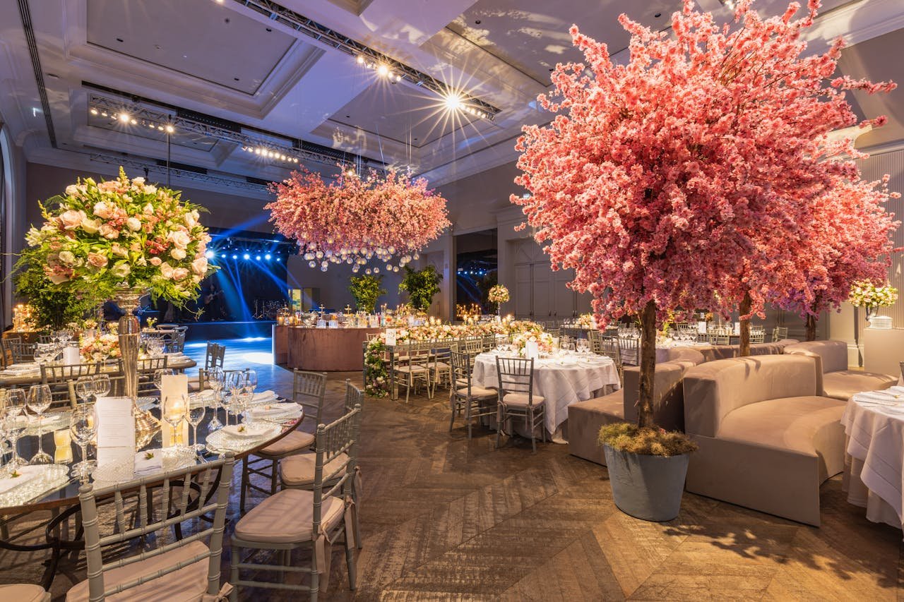 Elegant wedding reception with cherry blossoms and lavish decor in a luxurious setting.